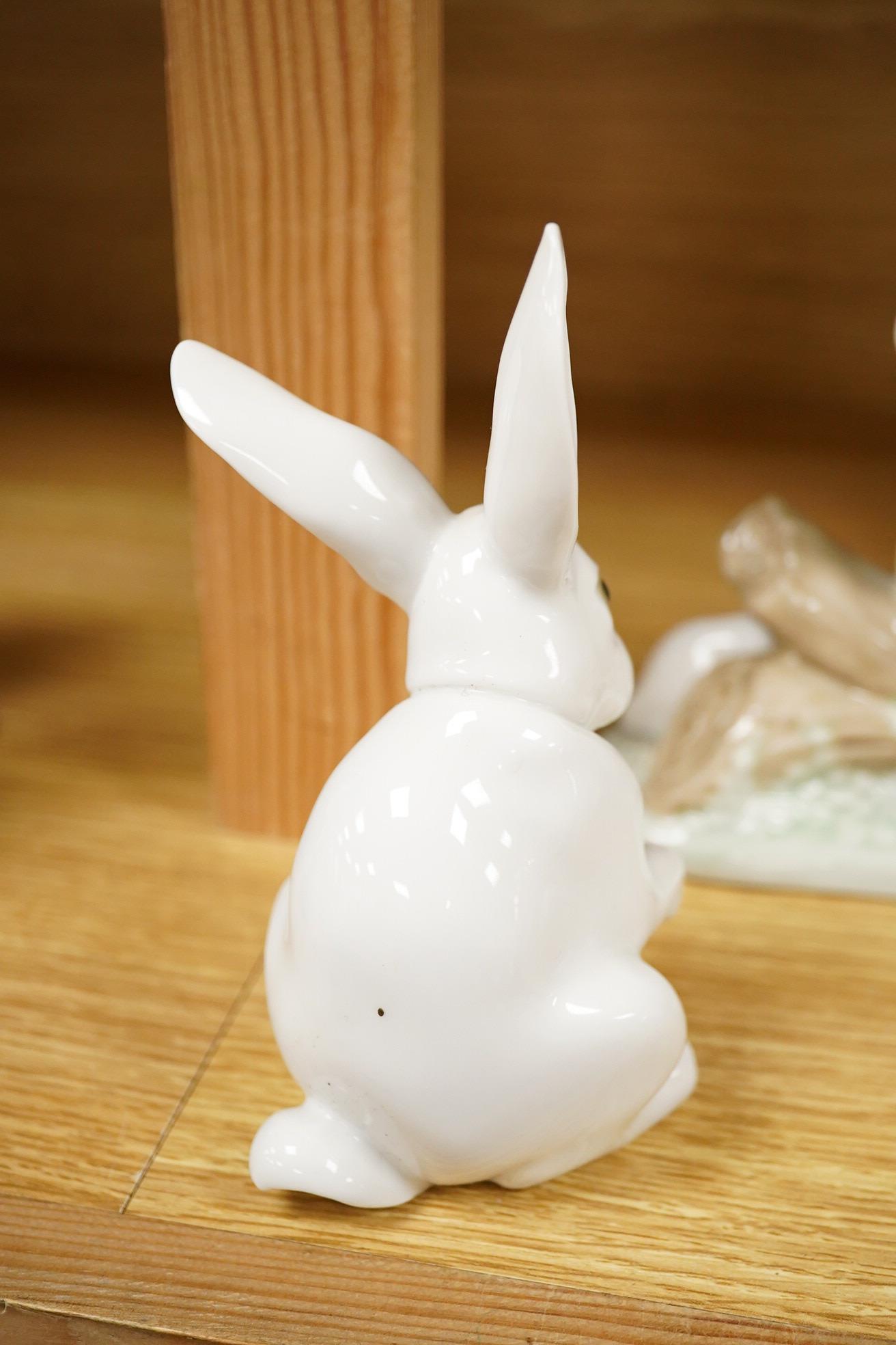 Four Lladro and Nao figures and a Doulton Toby jug, The Lawyer, largest 20cm high